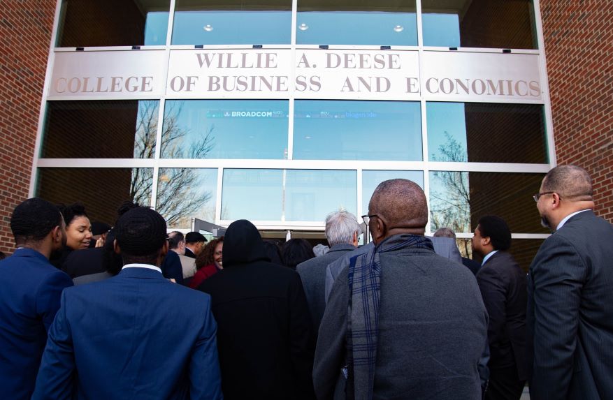 A crowd of business professionals entering Craig Hall