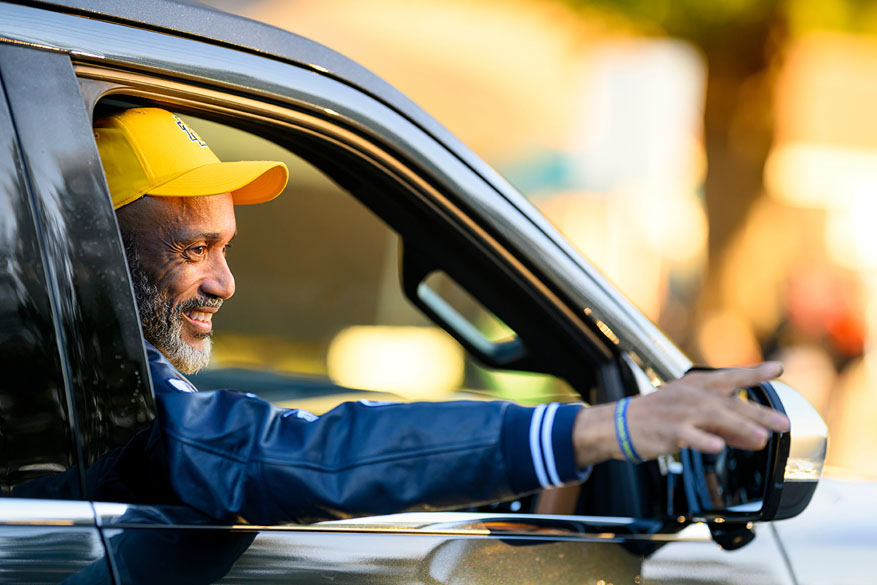 Homecoming parade with the Blue and Gold Marching Machine leading the way